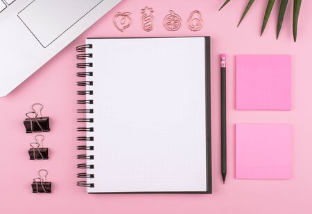 Home office, stationery, Notepad, computer, flower on pink background, copy spaceの写真素材