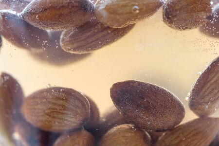 almond kernels soaked in water close-up, delicious macroの写真素材