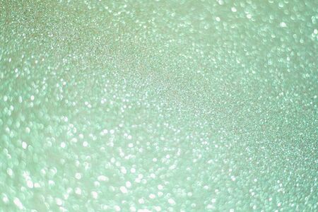 Sparkling bokeh background in a fresh emerald color. turquoise sequins background.の写真素材