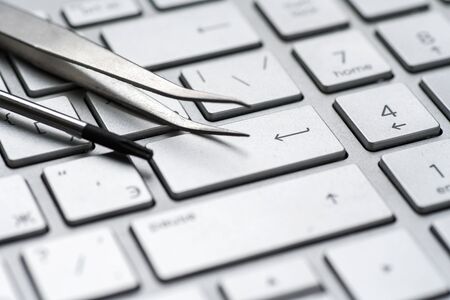 Laptop repair, screwdrivers close-up on a gray keyboard. Computer serviceの写真素材