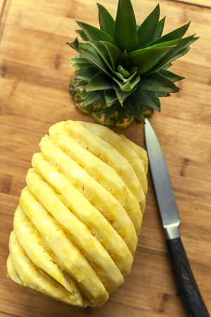 Ripe perfectly peeled pineapple, on a wooden background.の写真素材