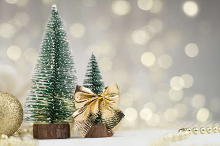 decorative Christmas trees decorated and gifts for the new year on the bokeh background, new year mood 2021の写真素材