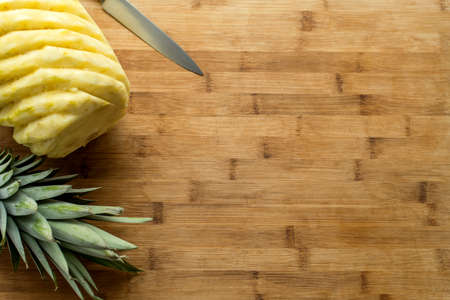 Ripe perfectly peeled pineapple, on a wooden background.の写真素材