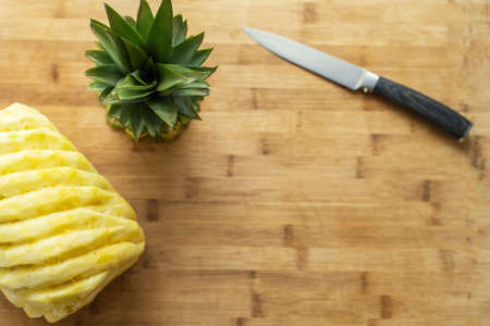 Ripe perfectly peeled pineapple, on a wooden background.の写真素材
