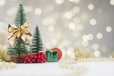 decorative Christmas trees decorated and gifts for the new year on the bokeh background, new year mood 2021の写真素材