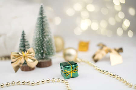 Two little Christmas trees decorated and gifts for the new year on the bokeh background, new year compositionの写真素材