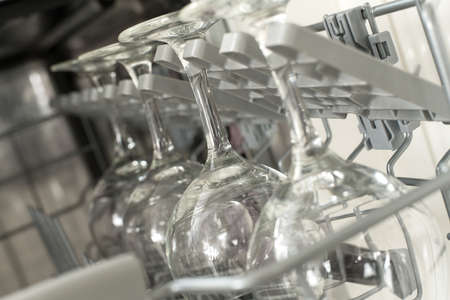glasses of wine are stacked rhythmically in the dishwasher.の写真素材