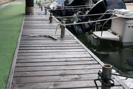 Close-up of a rope tied around the pier, moored shipの写真素材
