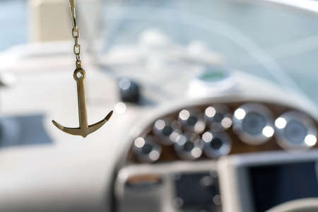 sea Golden anchor on the background of a bokeh yacht in the sea in the sunの写真素材