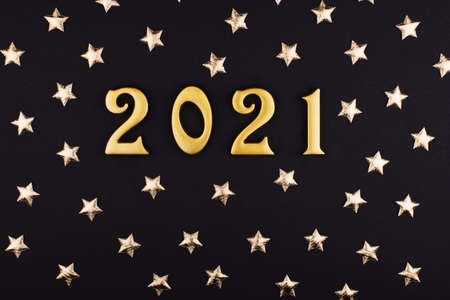 Happy New Year 2021. Sparkling gold numbers on black background with stars. object for design holiday greeting card,の写真素材