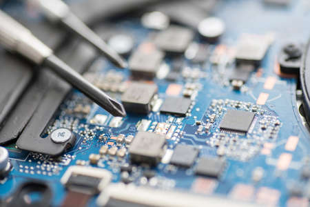 Professional repair of computers, laptops, boards. Screwdrivers, macro, close-upの写真素材
