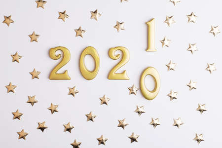 Happy New Year 2021. Sparkling gold numbers on white background with stars. object for design holiday greeting card,の写真素材