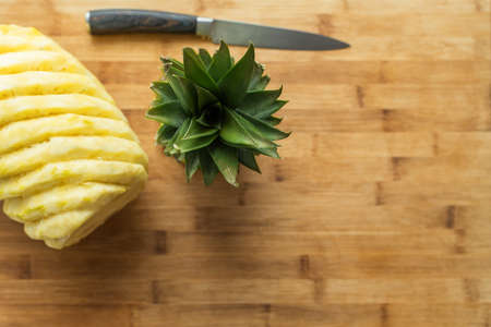 Ripe perfectly peeled pineapple, on a wooden background.の写真素材