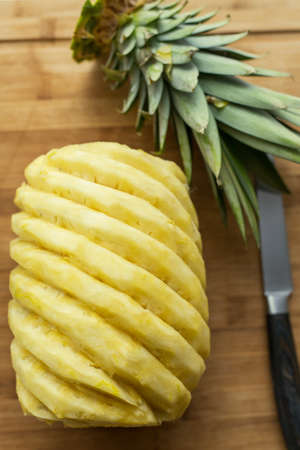 Ripe perfectly peeled pineapple, on a wooden background.の写真素材