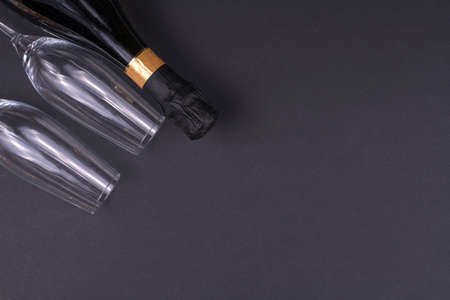 a bottle of champagne and glasses on black buckgroundの写真素材