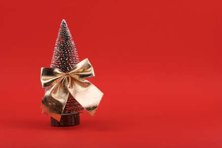 Decorated Christmas tree isolated on red backgroundの写真素材