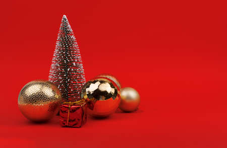 Decorated Christmas tree, gifts on red backgroundの写真素材
