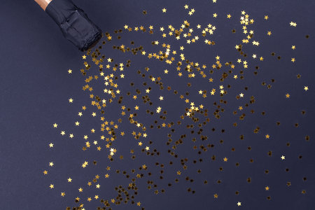 Celebration theme with champagne splashes on a black background with sequins and free space. Christmas or New Year, background.の写真素材