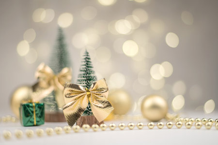 decorative Christmas trees decorated and gifts for the new year on the background of Golden bokeh lights, new year background, new year mood 2021.の写真素材