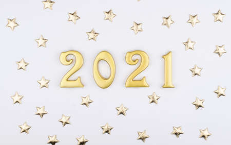 Happy New Year 2021. Sparkling gold numbers on white background with gold stars.の写真素材