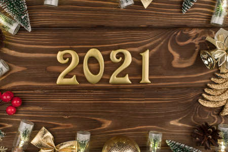 new year 2021 Golden numbers on wooden background with new year decor, Happy Christmas backgroundの写真素材