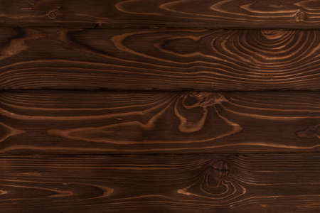 Texture of burnt brown dark wood, blackboard backgroundの写真素材