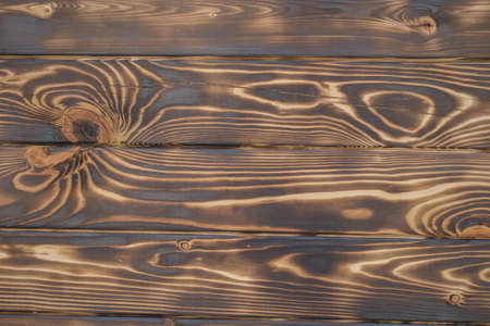 Texture of burnt brown dark wood, blackboard backgroundの写真素材