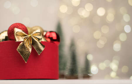 Christmas background , red gift box with a Golden bow on the background of Christmas bokeh. Copy Spaceの写真素材