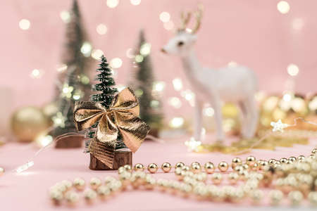 decorative Christmas trees decorated and gifts for the new year on the background of Golden bokeh lights, new year background, new year mood 2021.の写真素材