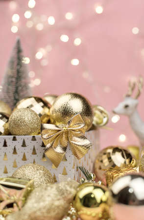 lots of Golden Christmas balls on pink background, New Year background bokehの写真素材