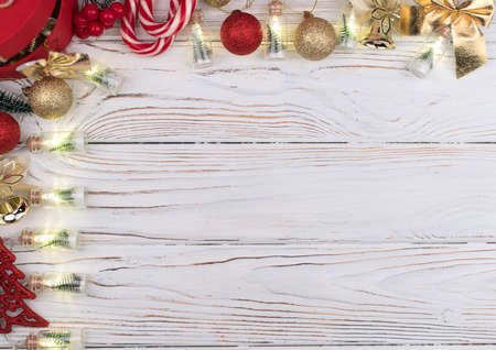 Christmas white wooden background top view. Template for New Year space for text congratulations. Holiday Greeting Cards Design. Christmas wooden background with red gift box.の写真素材