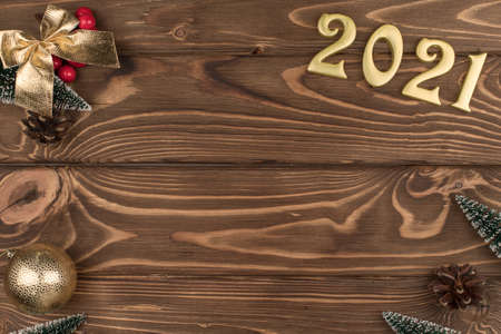 new year 2021 Golden numbers on wooden background with new year decor, Happy Christmas background.の写真素材