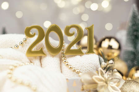 Numbers 2021 on Golden bokeh background New year mood, Christmas, greeting card, new year background.の写真素材