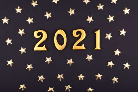 Happy New Year 2021. Sparkling numbers Year 2021 isolated on black background. golden overlay object for design holiday greeting card, billboard and Web bannerの写真素材