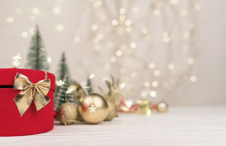 Christmas background , red gift box with a Golden bow on the background of Christmas bokeh. Copy Spaceの写真素材