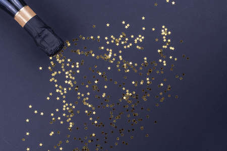 Celebration theme with champagne splashes on a black background with sequins. Christmas or New Year, background.の写真素材