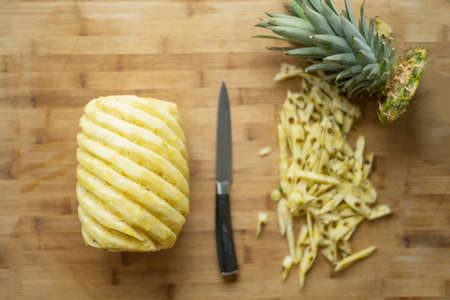 Ripe perfectly peeled pineapple, on a wooden background.の写真素材