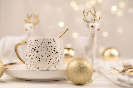 Beautiful composition with white Cup with the gold new year's drink.の写真素材