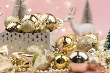 lots of Golden Christmas balls on pink background, New Year background bokeh.の写真素材