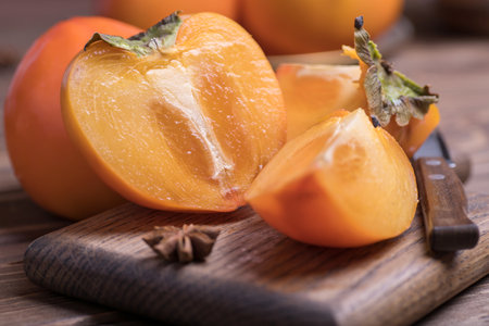 fresh ripe, orange jucy persimmons cut into slices, close-up.の写真素材