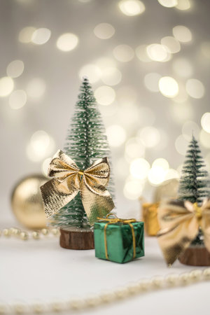 decorative Christmas trees decorated and gifts for the new year on the bokeh background, new year mood 2021の写真素材