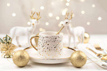 Beautiful composition with white Cup with the gold new year's drink.の写真素材