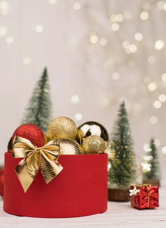 Christmas background, gift box with a Golden bow on the background of Christmas bokehの写真素材