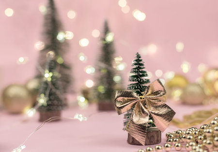 decorative Christmas trees decorated and gifts for the new year on the background of Golden bokeh...