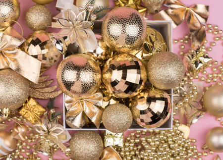 lots of Golden Christmas balls on pink background, New Year background bokeh.の写真素材