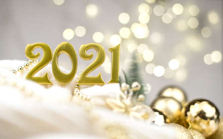 Numbers 2021 on Golden bokeh background New year mood, Christmas, greeting card, new year background.の写真素材