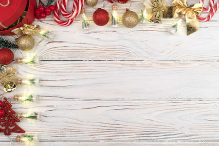 Christmas white wooden background top view. Template for New Year space for text congratulations. Holiday Greeting Cards Design. Christmas wooden background with red gift box.の写真素材