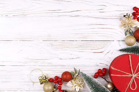 Christmas white wooden background top view. Template for New Year space for text congratulations. Holiday Greeting Cards Design. Christmas wooden background with red gift box.の写真素材