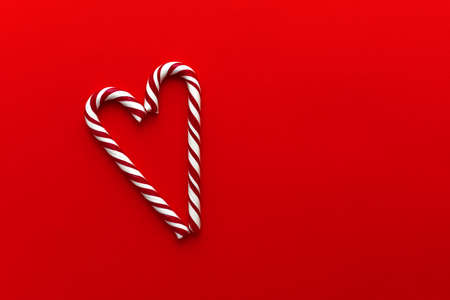 Two candy canes making a heart on a red textured background, Candy cane heartの写真素材