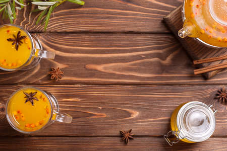 Beautiful glass teapot with sea buckthorn tea. Hot winter drinks.の写真素材